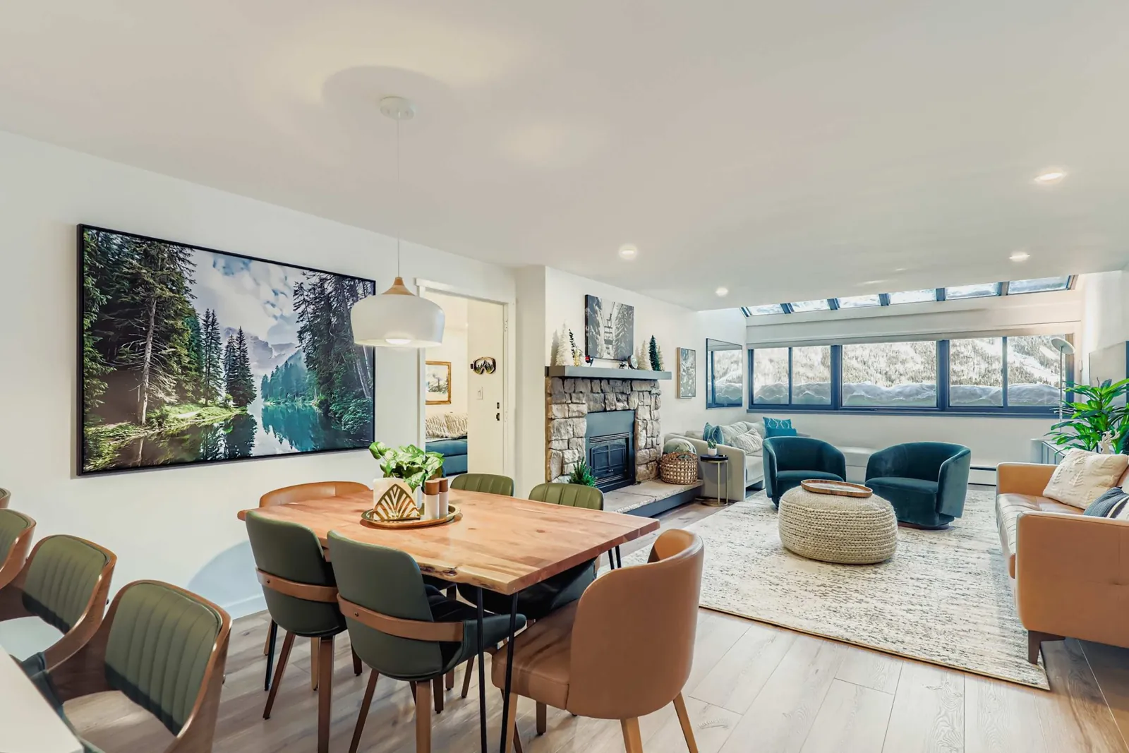 The spacious designer living and dining area in Lark Mountain’s Village Square penthouse